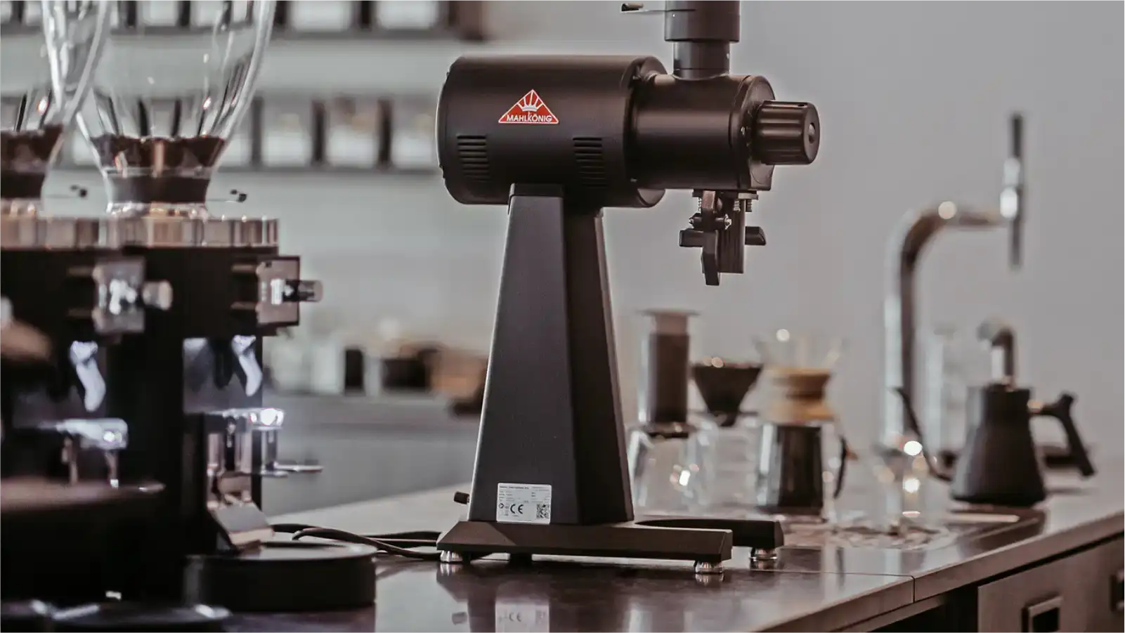 Side-by-side comparison of Mahlkönig E65S and Victoria Arduino Mythos grinders showing burr differences